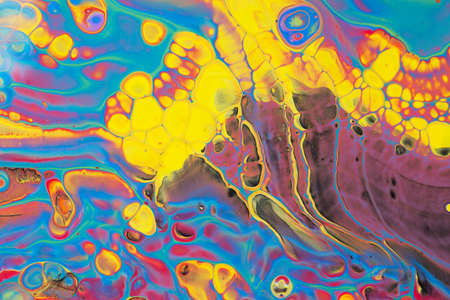 Abstract background of acrylic paint in blue red and yellow tones