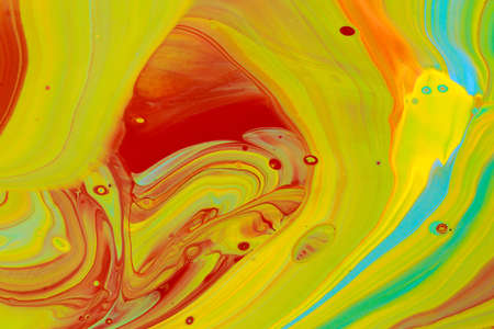 Abstract background of acrylic paints in orange and green color tones