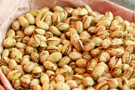 Pistachios in a paper bag close upの写真素材