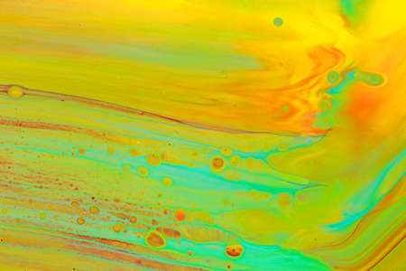 Abstract background of acrylic paints in orange and green color tonesの写真素材