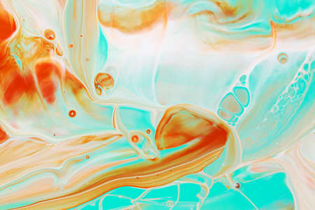 Abstract background of acrylic paints in aquamarine and orange color tones