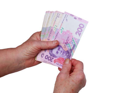 Money in old female hands on a white background