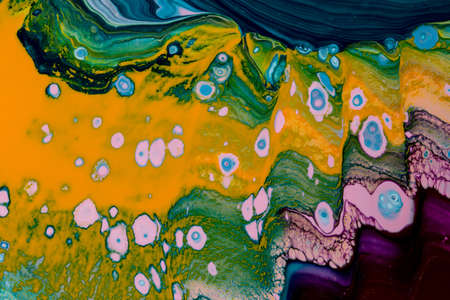 Abstract background of acrylic paint in purple and yellow tones