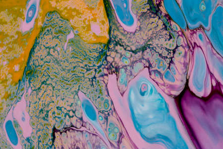 Abstract background of acrylic paint in yellow and aquamarine tones