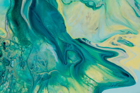 Abstract background of acrylic paint in yellow and aquamarine tonesの写真素材