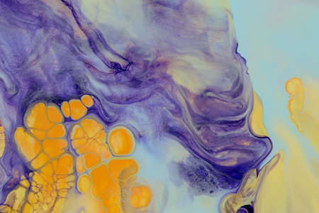 Abstract background of acrylic paint in yellow and purple tones