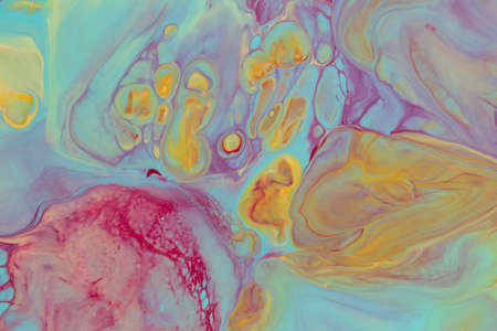 Abstract background of acrylic paint in yellow and purple tones