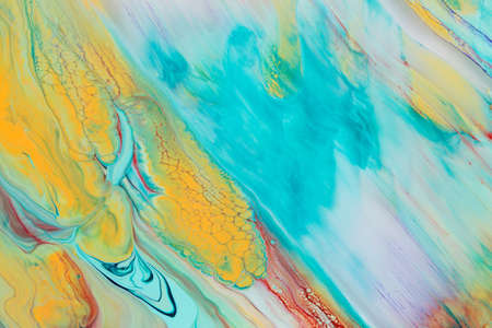 Abstract background of acrylic paint in yellow and aquamarine tones