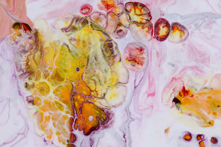 Abstract background of acrylic paint in yellow and red tones