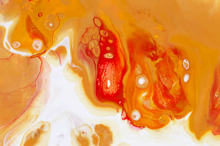Abstract background of acrylic paint in yellow and red tones