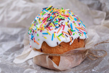Muffin with white icing and cinnamon sticks
