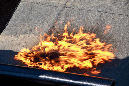 Fire on the background of roofing material