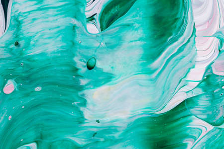 Abstract background of acrylic paint in green and pink tones