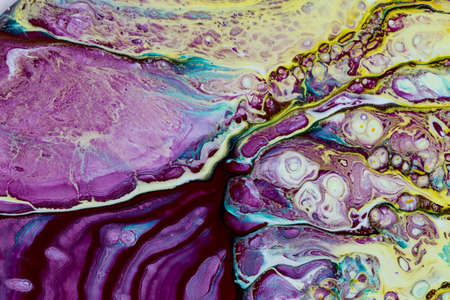 Abstract background of acrylic paint in purple and yellow tones