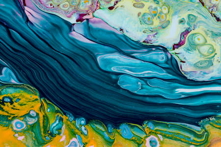 Abstract background of acrylic paint in yellow and aquamarine tones
