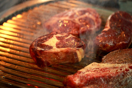 Various raw cuts of meat on the grill.の写真素材