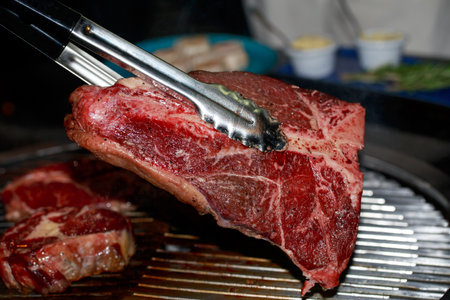 Raw piece of porterhouse beef steak on a grill background.の写真素材