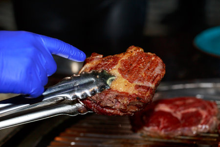 Piece of grilled beef on a barbecue background.の写真素材