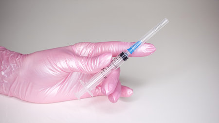 Hands in gloves and with a medical syringeの写真素材
