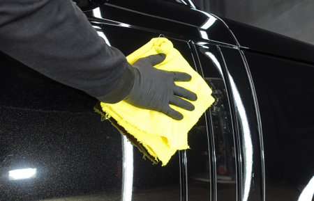 Wiping a clean car with a ragの写真素材