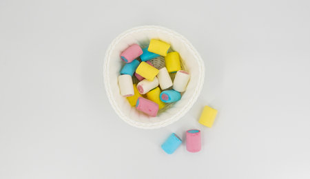 White vase with colored marshmallowsの写真素材