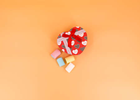Heart-shaped gift box and candy with isolated backgroundの写真素材