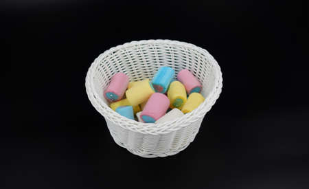 White vase with colored marshmallowsの写真素材