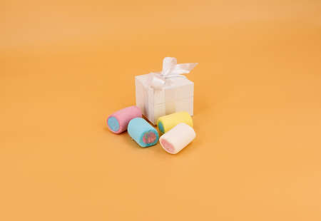 White gift box with colored marshmallowsの写真素材