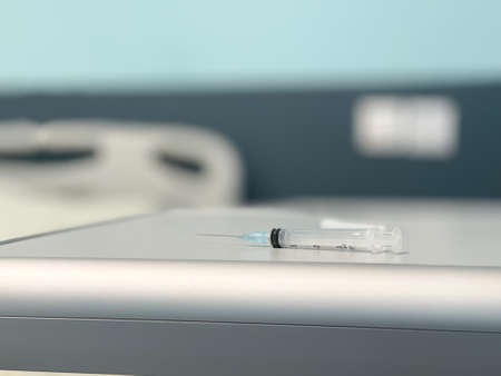 The syringe is on the bedside table in the hospital roomの写真素材