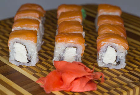 The set of philadelphia salmon rolls on bamboo board. Side viewの写真素材