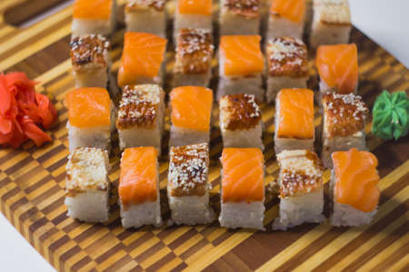 The set of rolls with ginger and wasabi on bamboo boardの写真素材