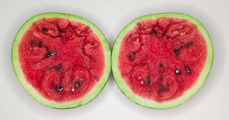 Two halves of a watermelon on a white backgroundの写真素材