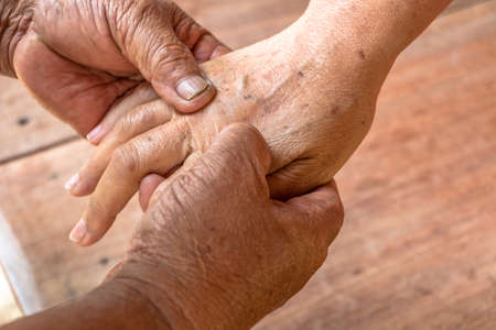 Close up woman hand massage by old man's handsの写真素材
