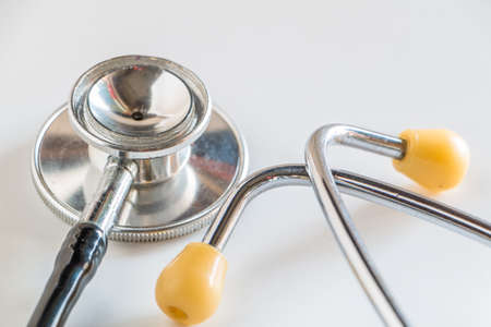 Stethoscope with tools on white background