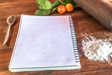 Write book with ingredient  herbs and spices on wooden backgroundの写真素材