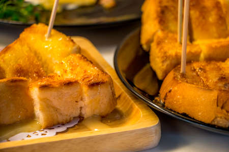 Bread topped with dried shredded pork put on wooden plate.の写真素材