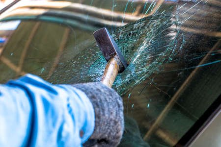 Technician use hammer for Broken car windshield. Selective focus.の写真素材
