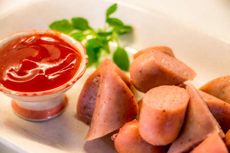 Sausage grill put on white plate serve with tomato sauceの写真素材