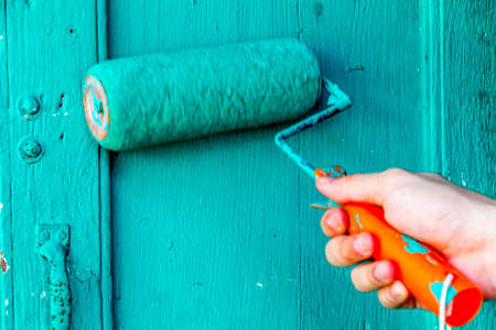 Hand use brush painting to the wall with green color.の写真素材