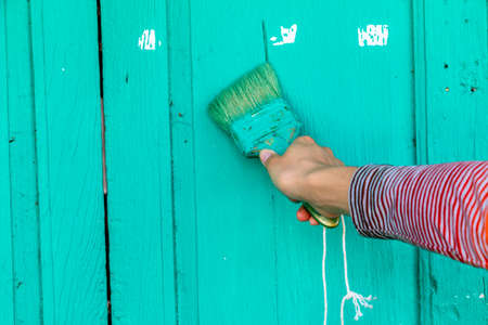 Hand use brush painting to the wall with green color.の写真素材