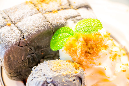 Charcoal  Toast put icecream Charcoal flavour on it with whip cream Decorate with mint leaves.の写真素材