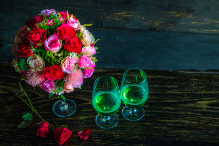 Green wine with bouquet package on old wooden, in love mood.の写真素材