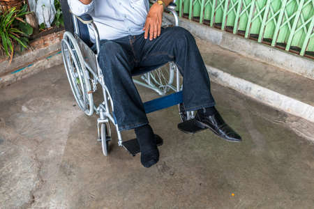 Man pushing an injured patient on a wheelchairの写真素材