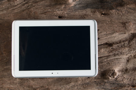 White smart phone with black screen on old wooden.