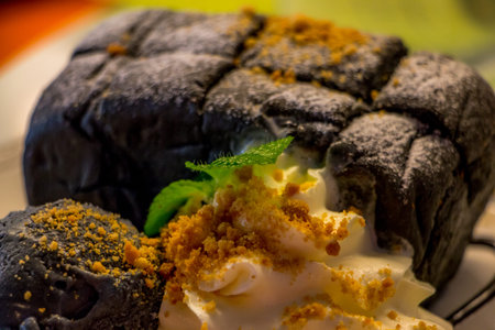 Charcoal  Toast put icecream Charcoal flavour on it with whip cream Decorate with mint leaves.