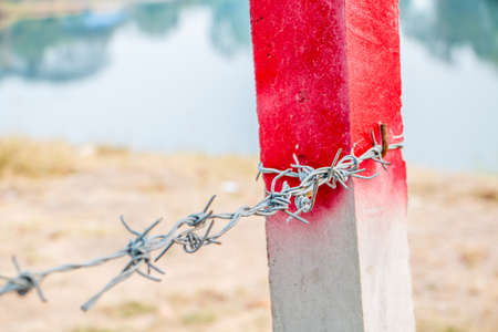 Barbed wire on concrete fence feel worrying.の写真素材