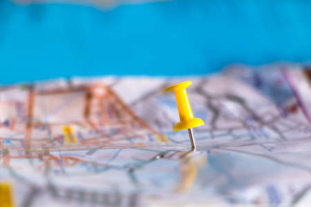 Travel destination pin points on a map with colorful thumbtacks and depth of field with select focus.の写真素材