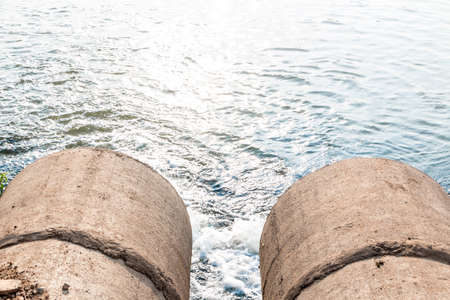 Unclean water from the sewer flows into the river.の写真素材