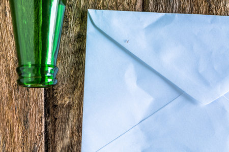 Old paper is placed on the table with a bottle of empty wine placed together.
