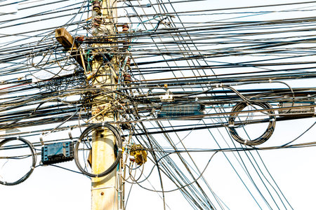 Electric Power lines are not working on a power pole tangled messy in city of Thailand.